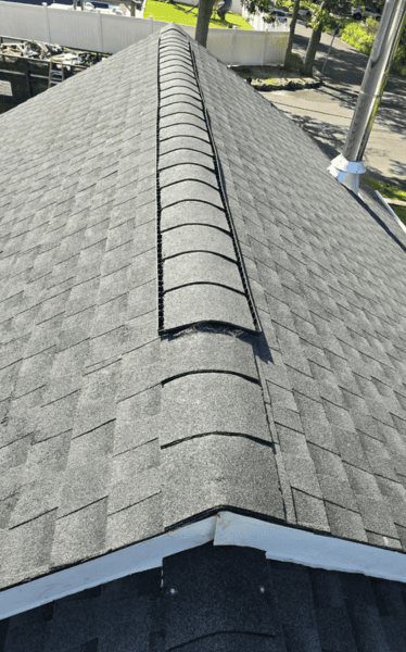 Ridge cap shingles over a ridge vent, the roof edge that takes the most wind on raised Oceanside canal homes